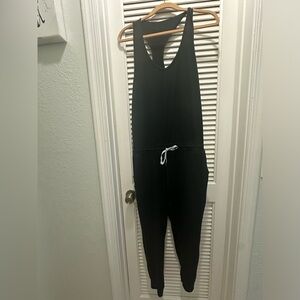 Black Vuori racerback jumpsuit with pockets